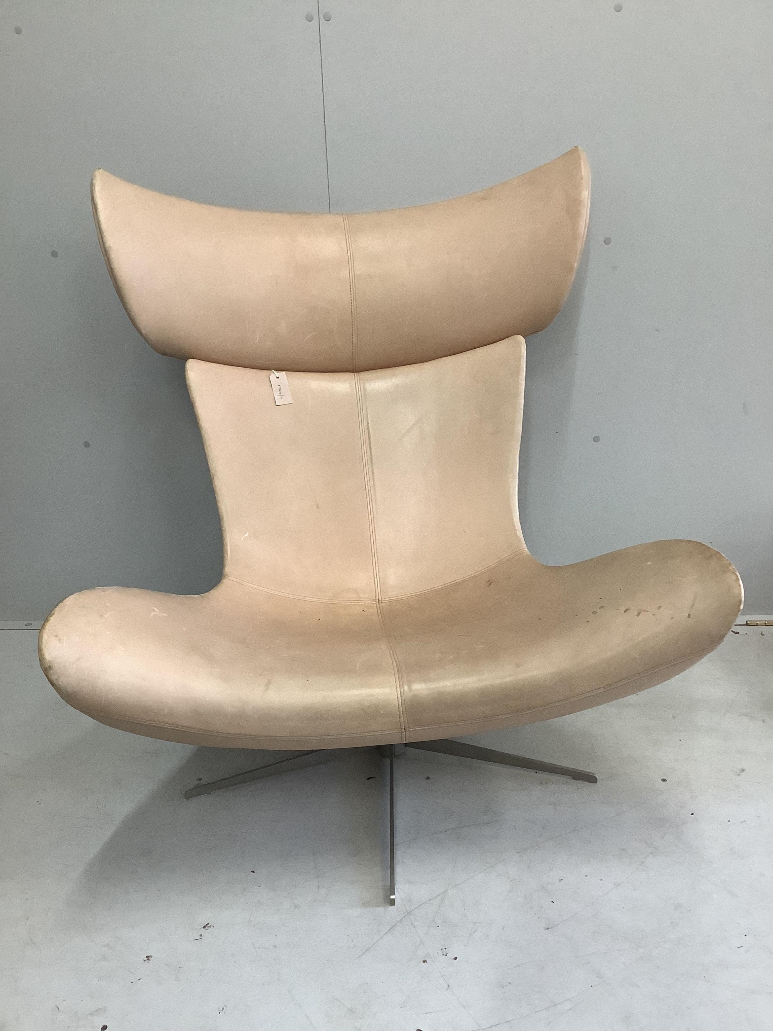 A Bo Concept Imola natural leather swivel chair, width 93cm, depth 90cm, height 110cm and footstool